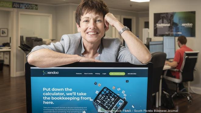 Lil Roberts standing in front of a computer with the xendoo site