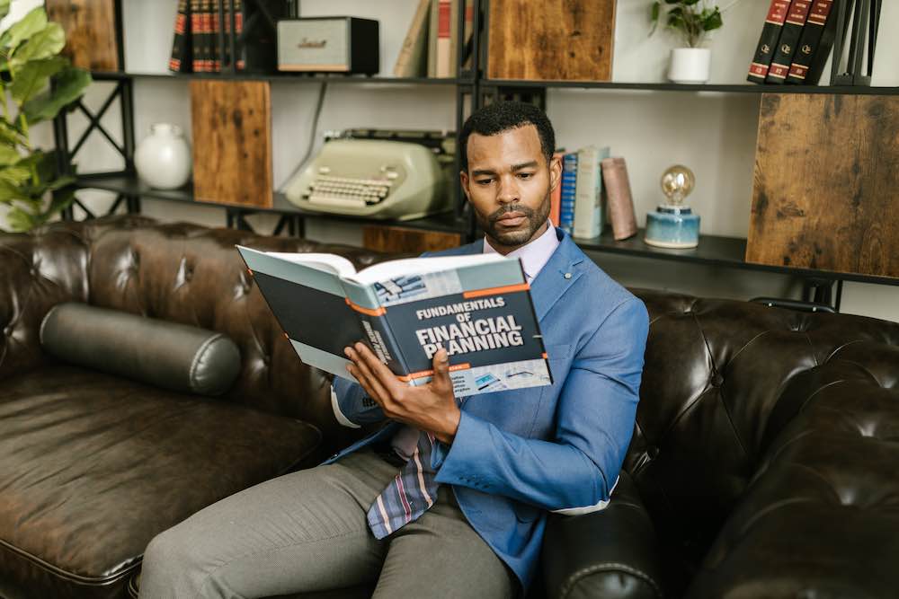 a man reading a book about financial planning