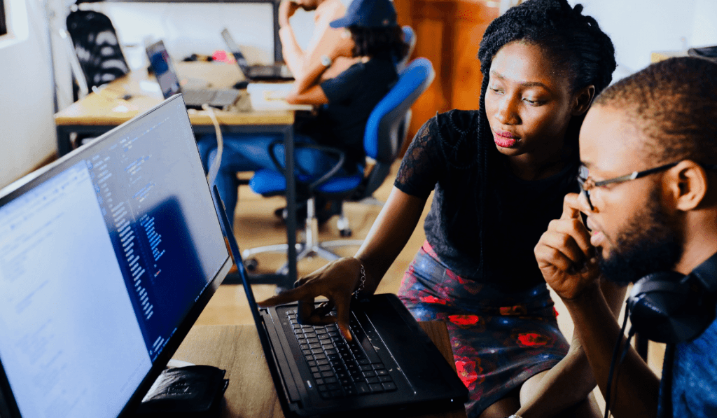 Two young black business owners working on a computer